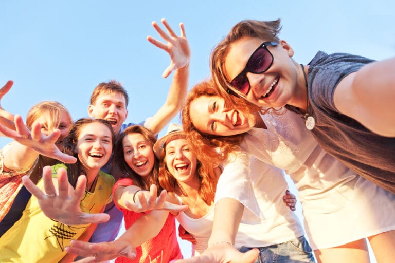 Group of happy young friends taking a selfie against a blue sky – Le Sentier des Pins, Ramatuelle