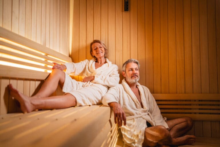 Senior couple relaxing and enjoying well being in sauna — Le Hameau des Oliviers à Vaison-la-Romaine