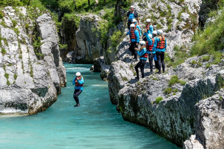 Jumping from a limestone rock into cold water – Canyoning