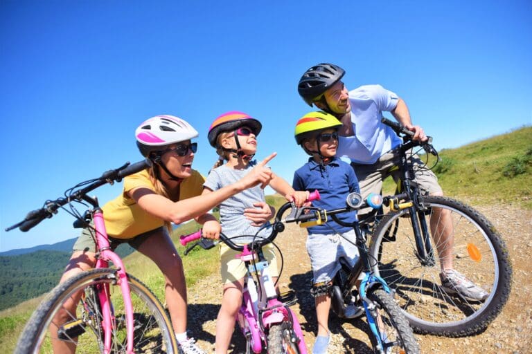 Family on a bike ride, parents pointing at the scenery – Mountain bike rides